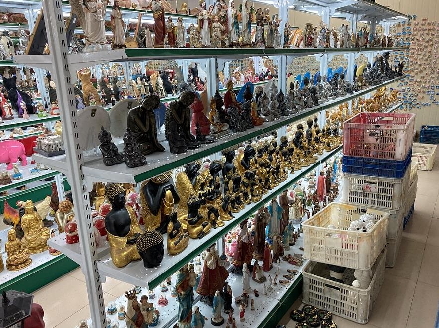 Retail home decor shelving with polyresin figurines and statues